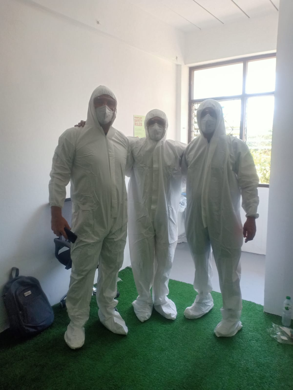 Three Sediña team members wearing protective clothing